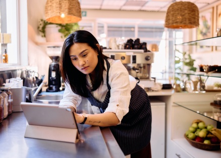 Small business owner reading up on international payroll costs