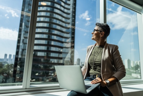 Businesswoman looking out the window in office in Uruguay