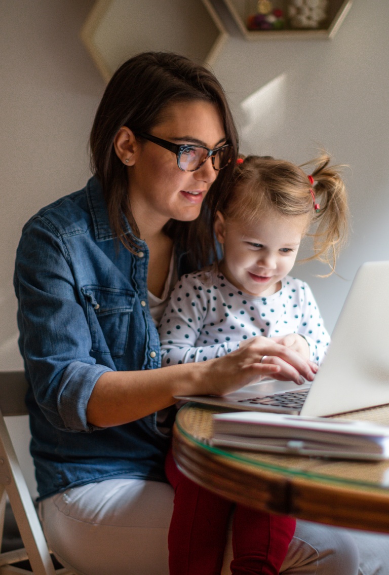 Woman with a child looking at laptop