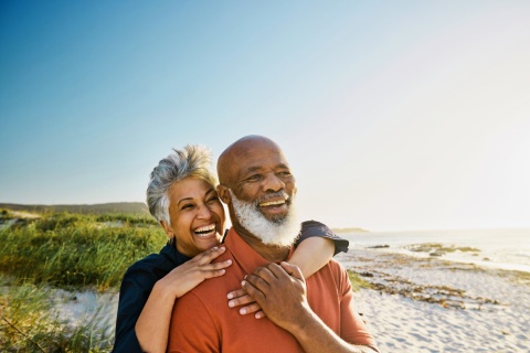 Couple smiling on a beach during the British Virgin Island’s public holidays