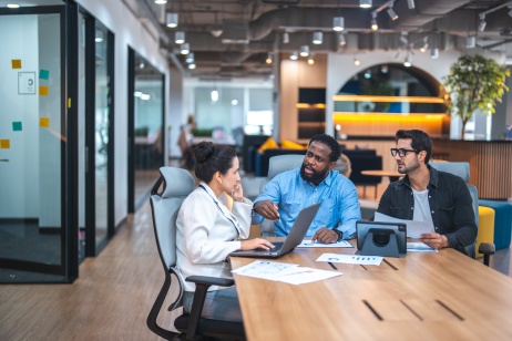 Team of three discussing global mergers and acquisitions with an EOR