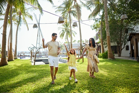 Happy family enjoying a resort garden during a Guayana public holiday
