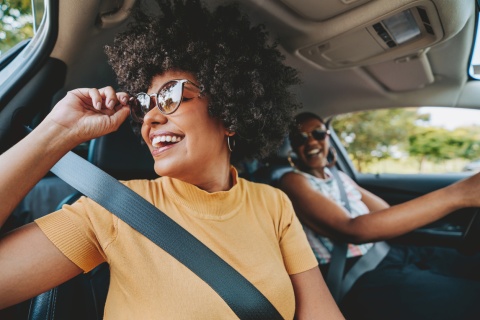 Happy friends traveling by car during a Ghana public holiday