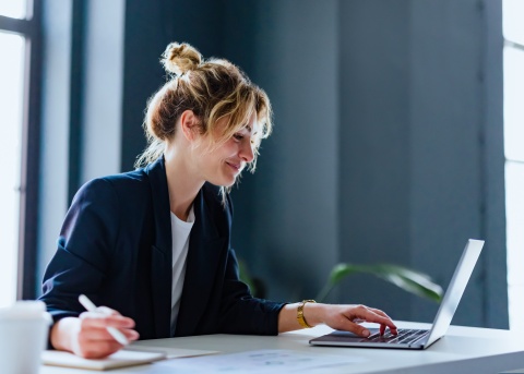 Female HR leader remotely facilitating virtual onboarding with a new hire from her laptop