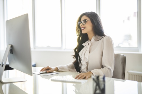 Young woman working on a computer in her office